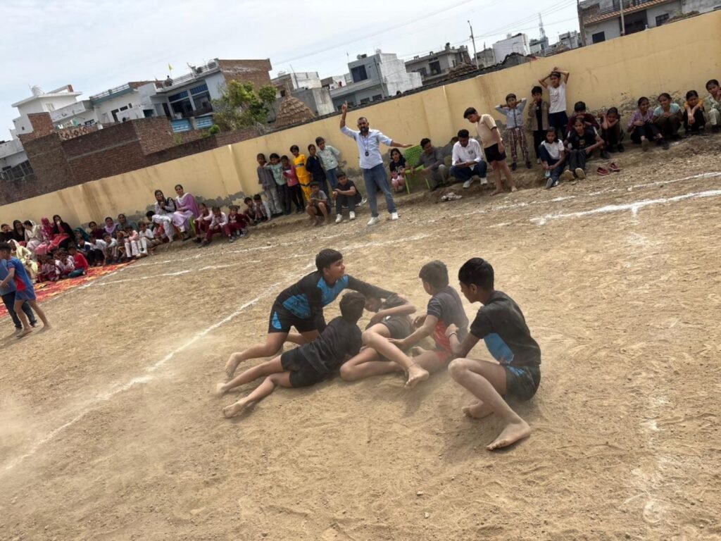 Students participating in a kabaddi match on the school sports ground.