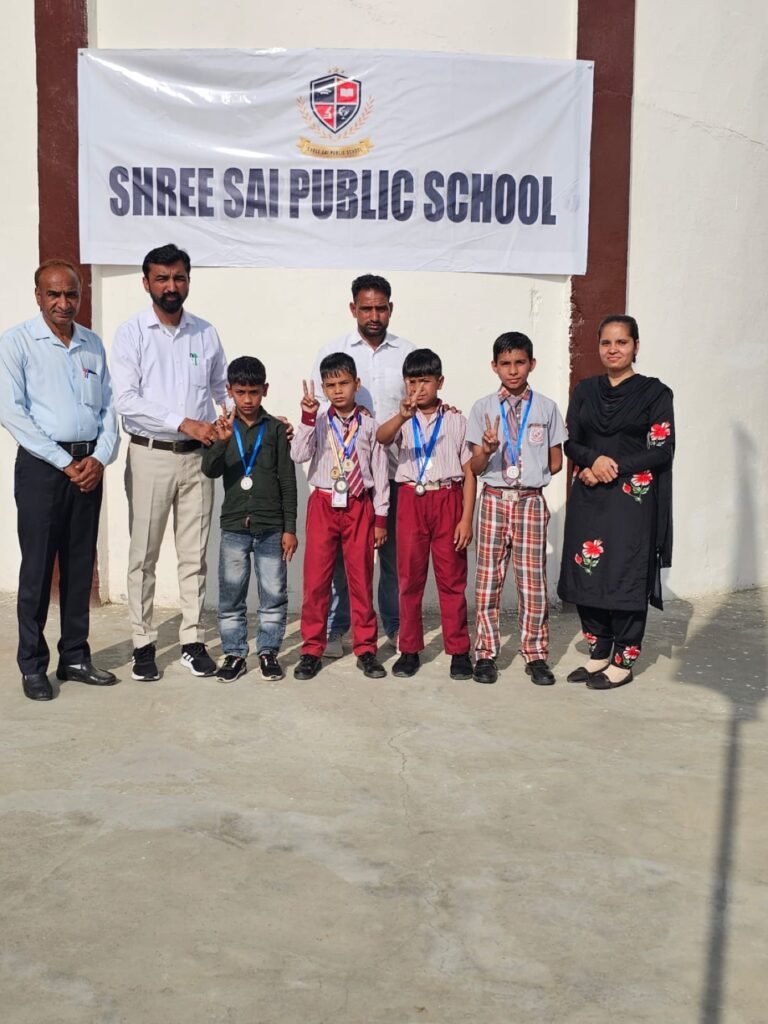 Young medal winners with school staff after a sports activity.