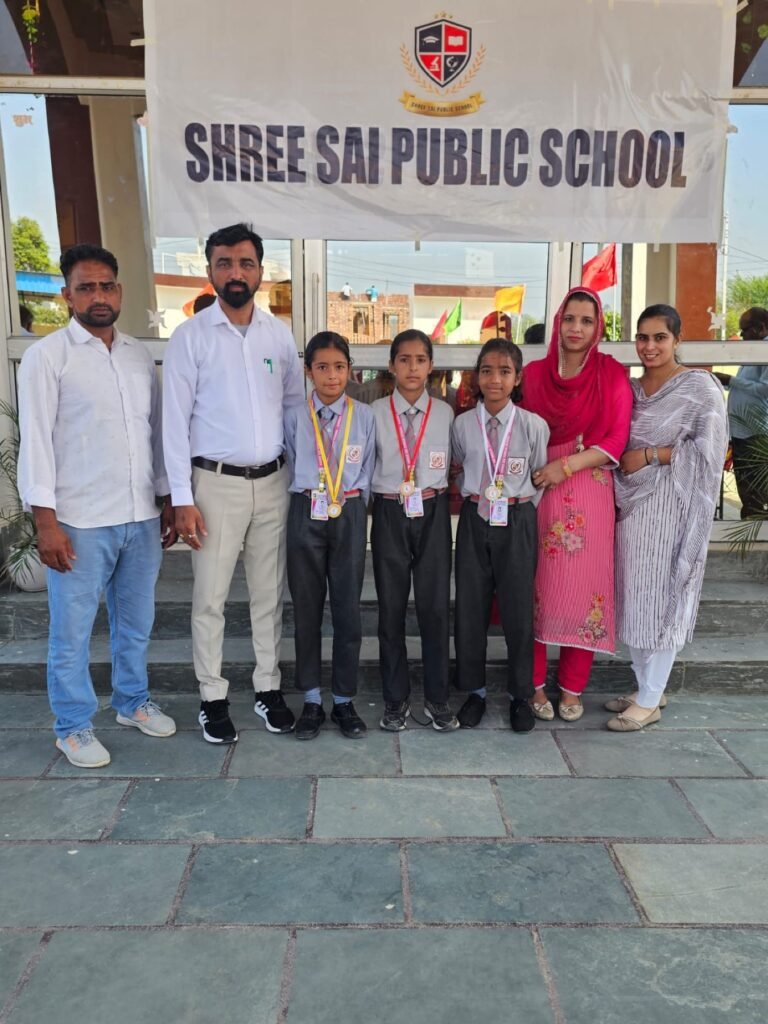 Students receiving medals with teachers at Shree Sai Public School.